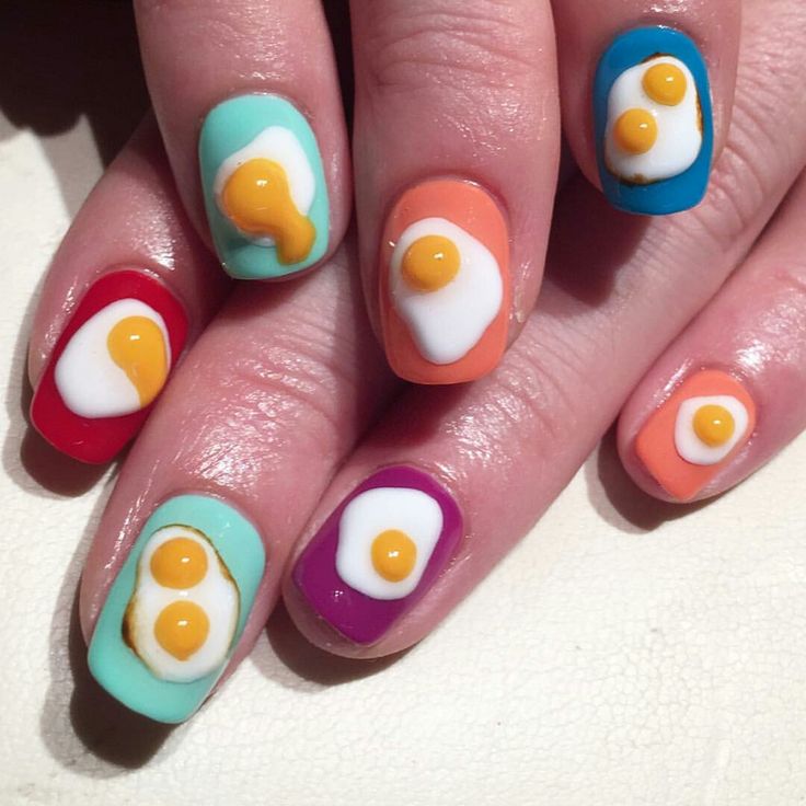 Playful Egg Motif Nail Design with Vibrant, Unique Backgrounds