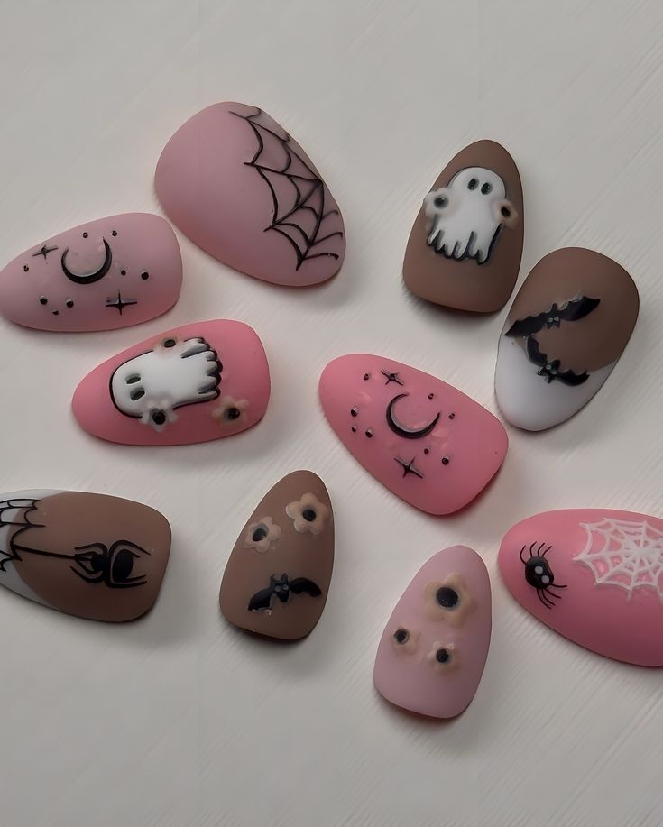 Playful Halloween Nail Art: Whimsical Motifs in Pastel Hues.