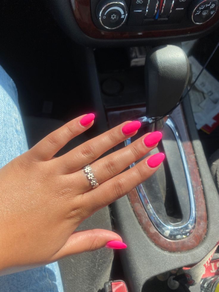 Elegant Vibrant Pink Oval Nails Enhance Casual Chic with a Glossy Finish and Delicate Silver Ring.