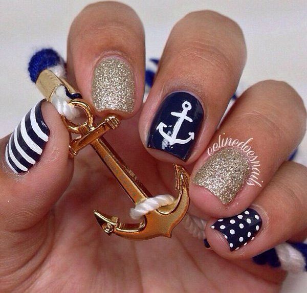 Nautical-Inspired Nail Design Featuring Navy Blue and Gold Glitter with Stripes, Polka Dots, and Anchor Charm.