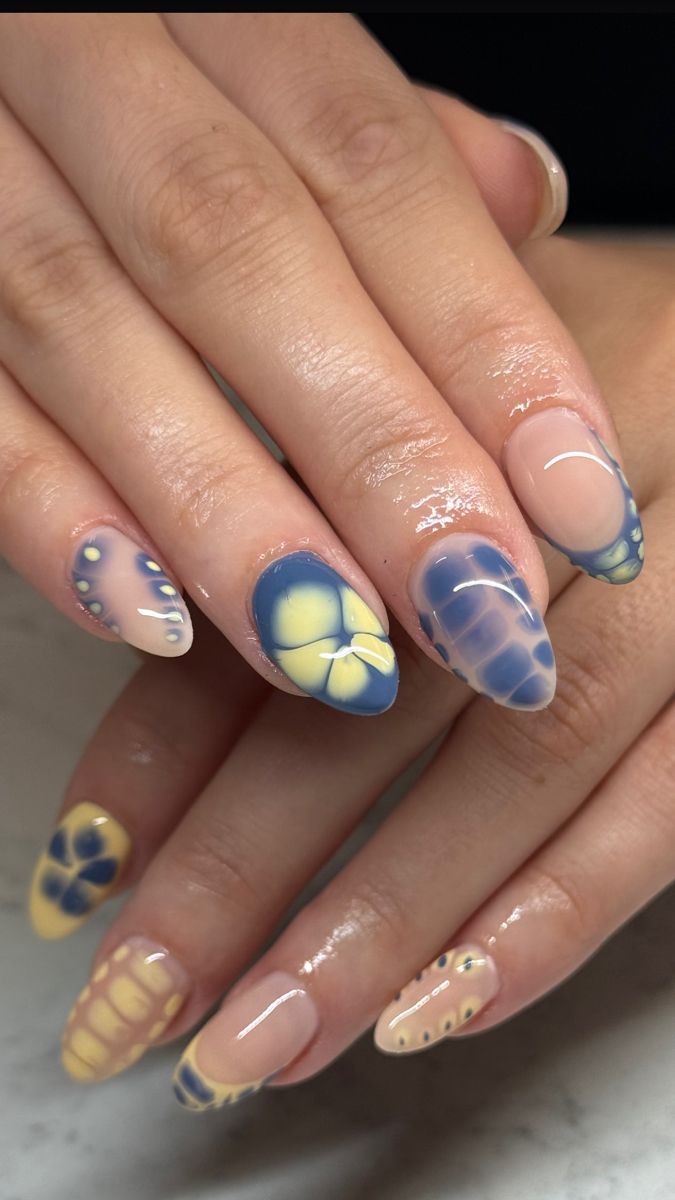 Vibrant Yellow and Blue Nail Design with Intricate Butterfly and Floral Patterns