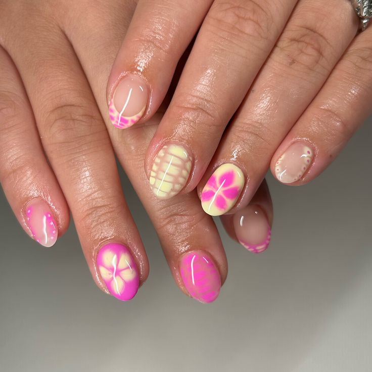 Playful Neon Pink and Pastel Nail Design with Floral and Geometric Patterns.