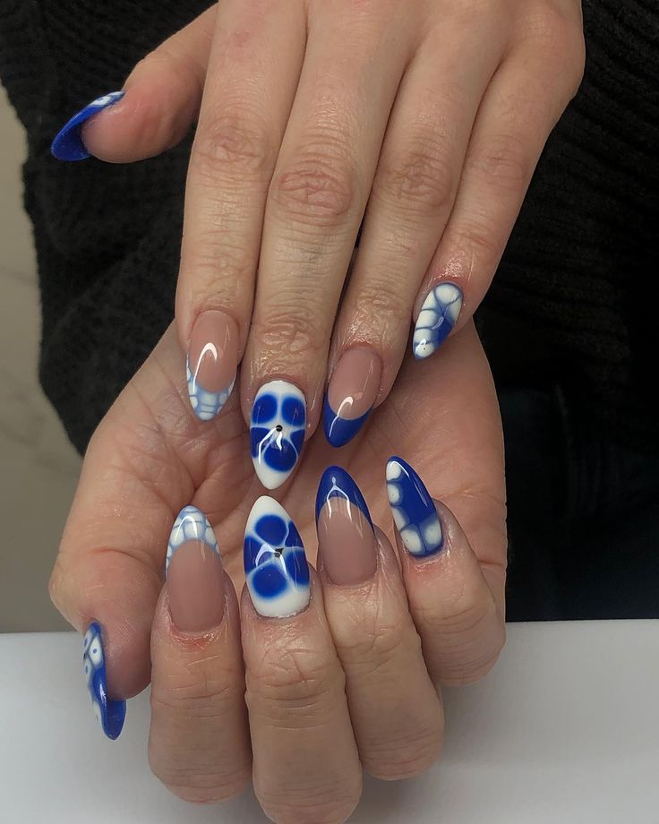 Elegant Blue and Nude Nail Art Design with Intricate Patterns and Pointed Shapes