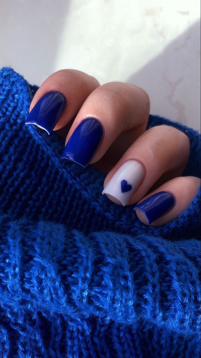 Bold Deep Blue and White Nail Design with Charming Heart Accent.