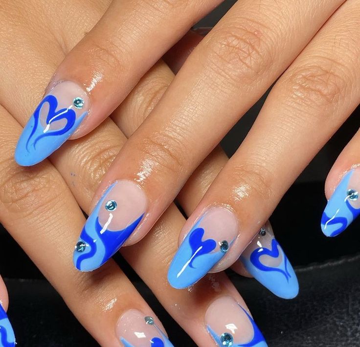 Bold and Elegant Vibrant Blue Nail Design with Artistic Swirls and Rhinestone Accents.