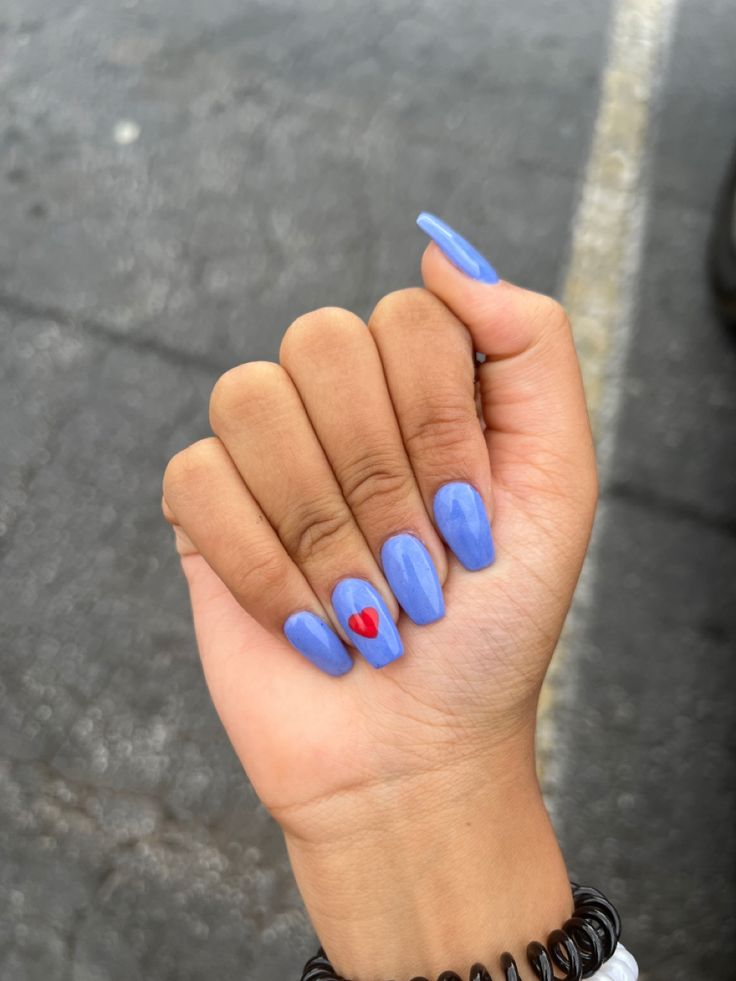 Chic Bold Blue Nail Design with Glossy Finish and Playful Red Heart Accent.