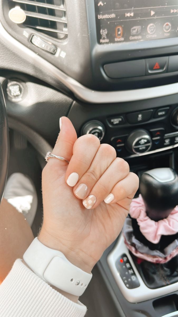 Chic Nude and White Nail Design with Modern Geometric Accent.