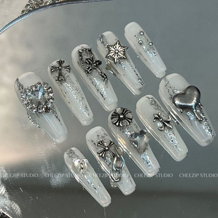 Elegant Sparkling Nail Design with Clear Acrylic Tips and Intricate Silver Embellishments.