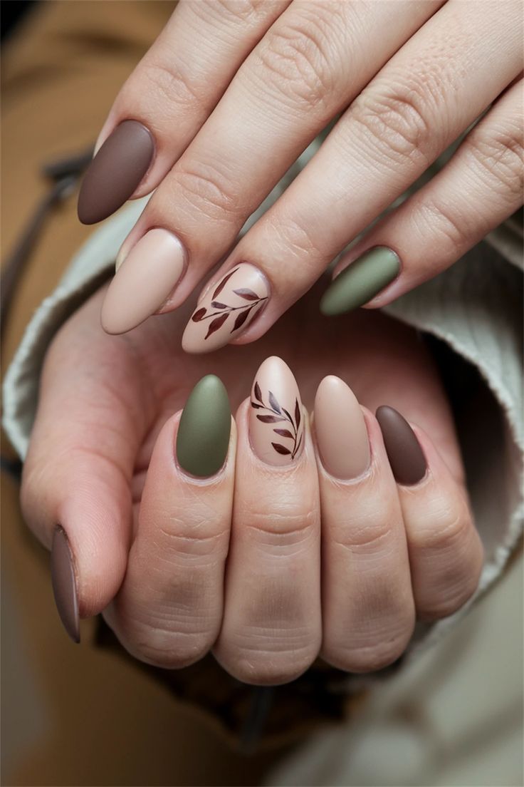 Chic Earthy Toned Nail Design with Matte Finish and Delicate Leaf Motifs.