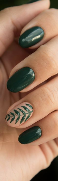 Sophisticated Deep Green Nail Design with Nature-Inspired Leaf Accents