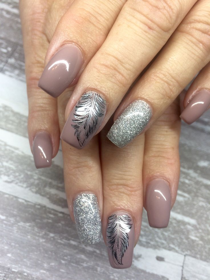 Chic Manicure: Muted Nude Base with Striking Silver Accents and Delicate Feather Patterns