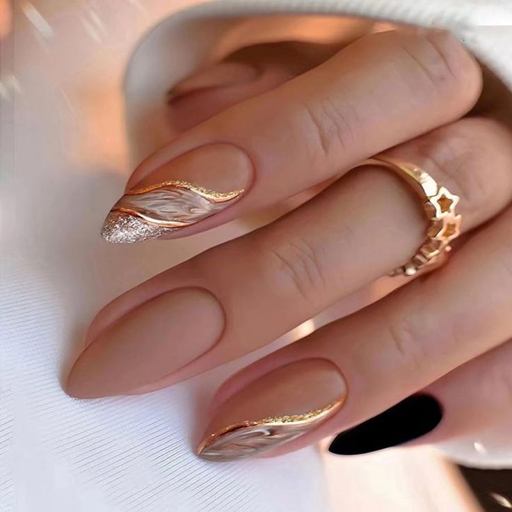 Sophisticated Oval Nail Design with Matte Beige, Glossy Gold, and Shimmering Silver Accents.