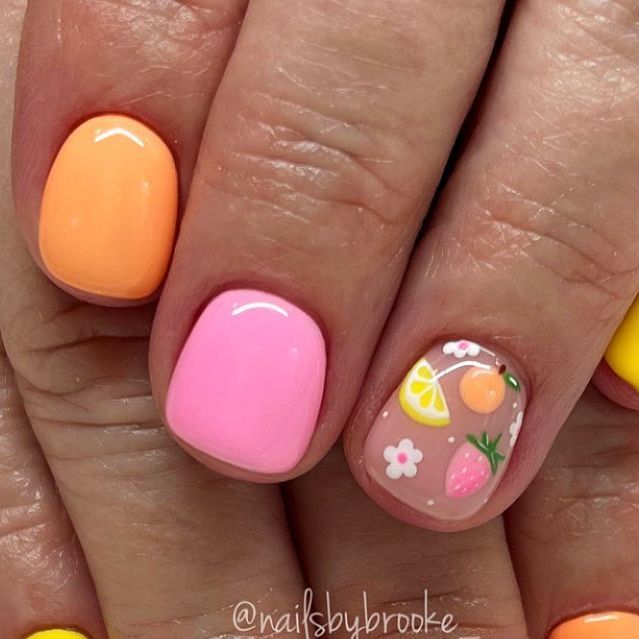 Vibrant Pastel Nail Design with Playful Fruit and Floral Accents for a Whimsical Summer Look.