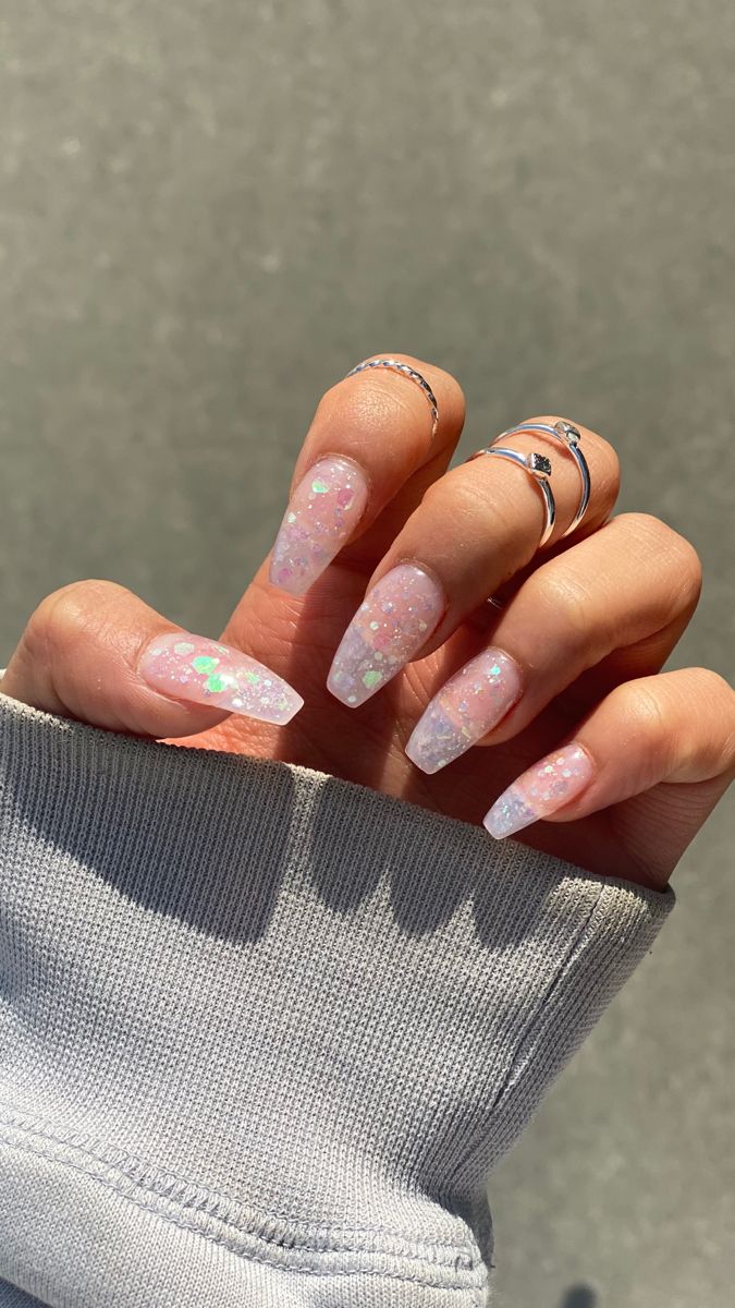 Whimsical Glittery Pastel Nail Design with Sparkling Touches and Silver Accents