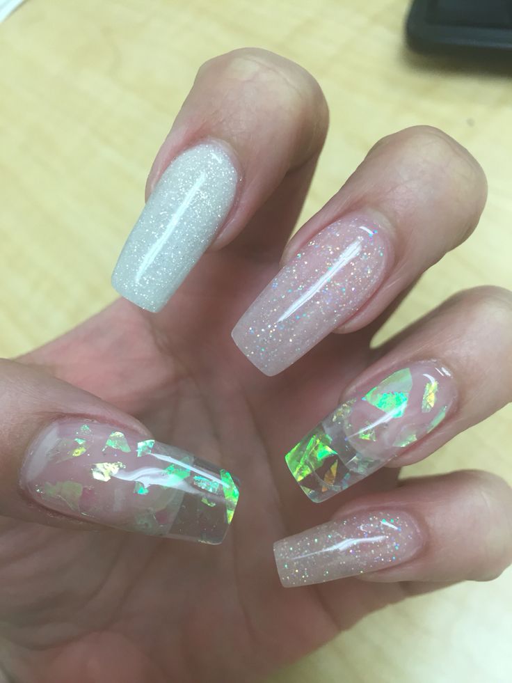 Sophisticated Nail Design: Shimmering Nude Tones with Iridescent Accents and Holographic Confetti Tips