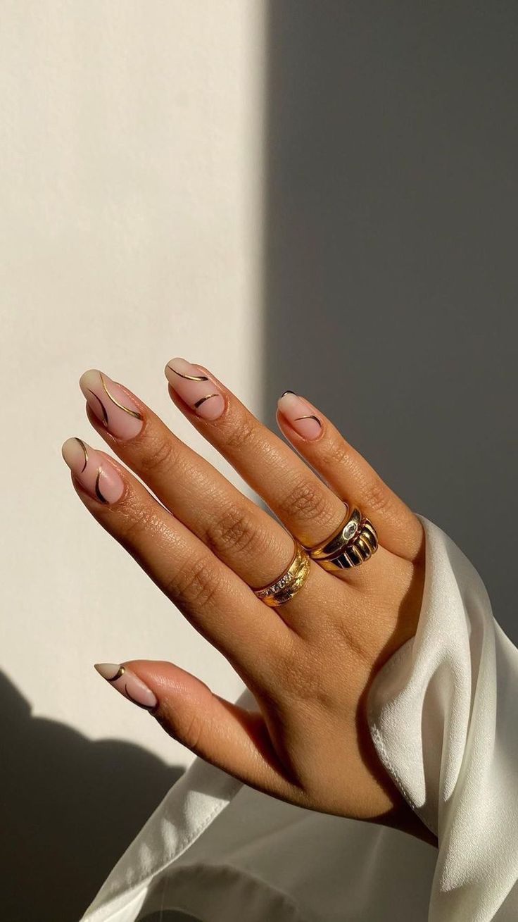 Chic Nude Marble Nail Design with Geometric Lines and Gold Accents