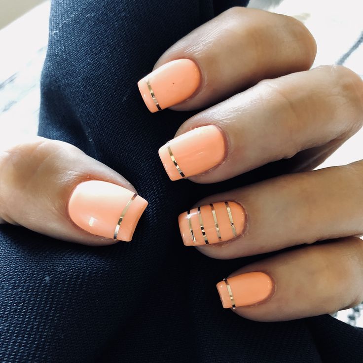 Chic Peach Nail Design with Metallic Stripes: A Modern Twist on Elegance.