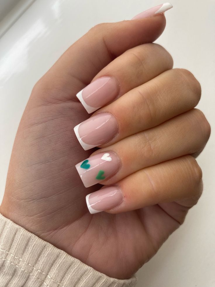 Sophisticated French Tip Nails with Playful Hand-Painted Hearts