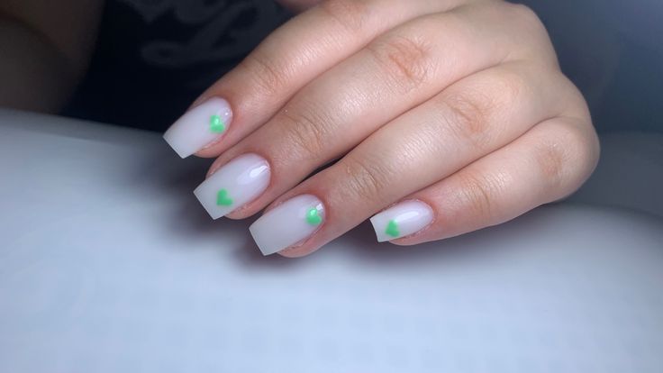 Playful Elegance: Sheer Green Heart Nail Design with Modern Square Shape.