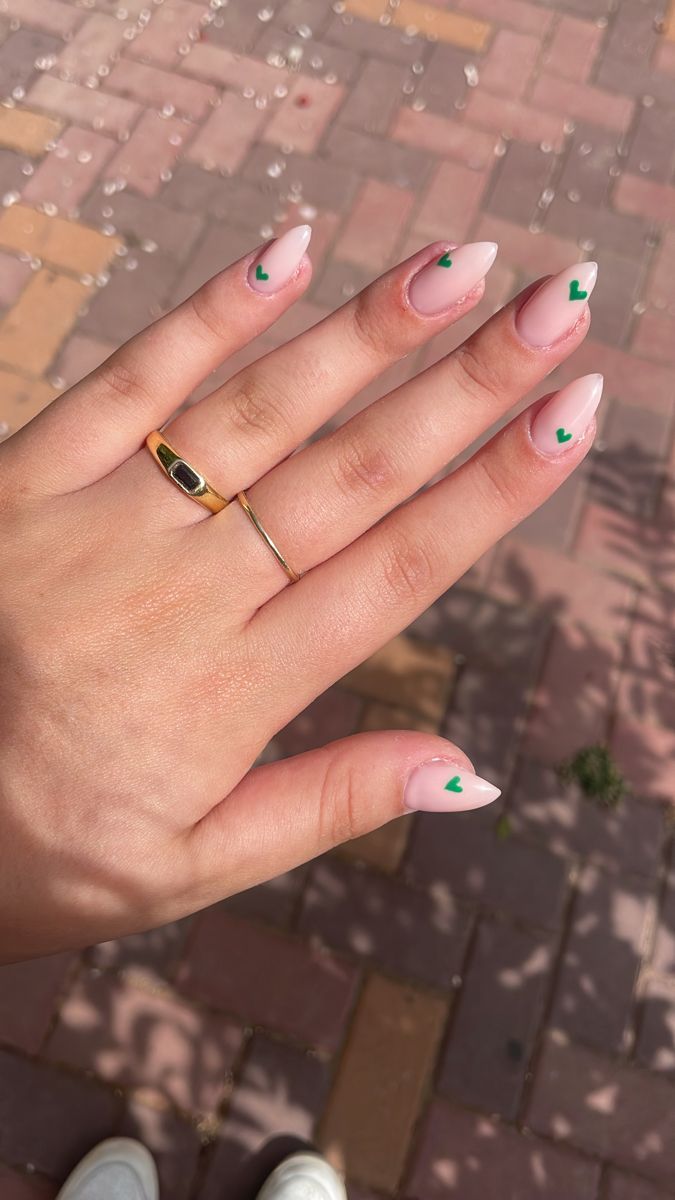 Elegant Nude French Tip Nails with Playful Green Heart Accents for a Refreshing Look.