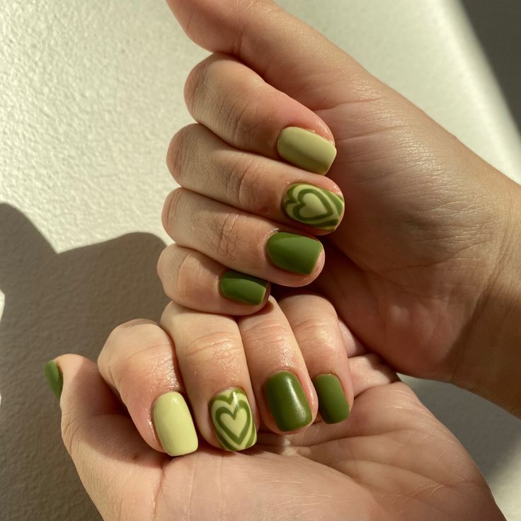 Harmonious Green Nail Design with Matte, Glossy Finishes and Heart Patterns.