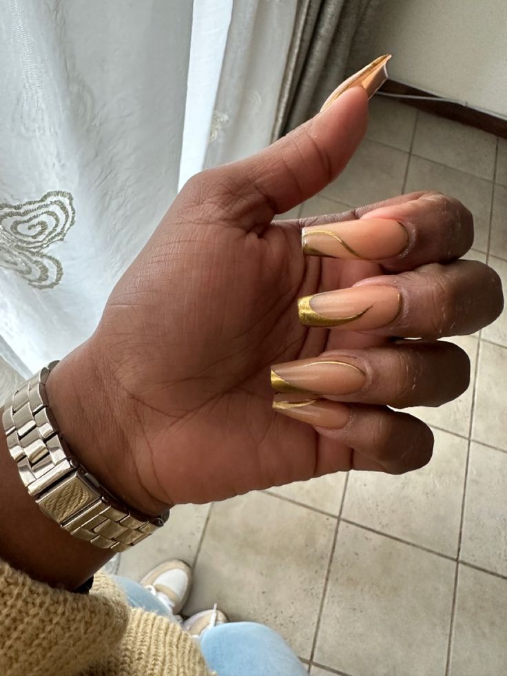 Elegant Nude and Gold Nail Design: A Trendy Twist on Sophistication