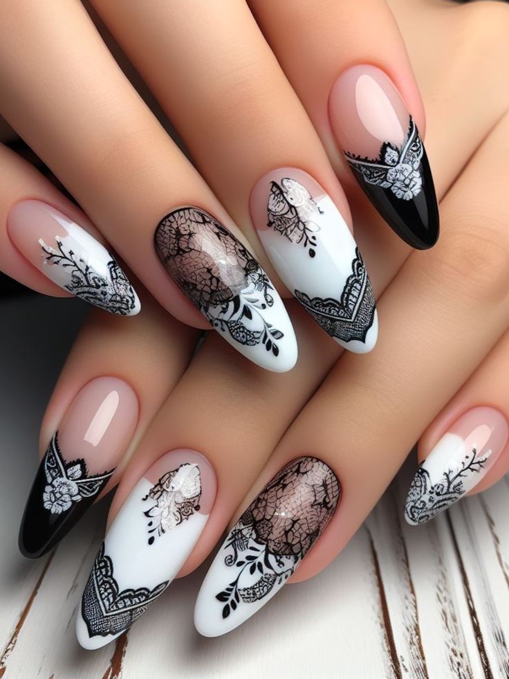 Sophisticated Black and White Nail Design with Intricate Floral Patterns and Varied Finishes.