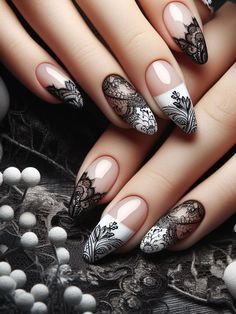 Sophisticated Black and White Nail Design with Intricate Lace Patterns and Floral Accents.