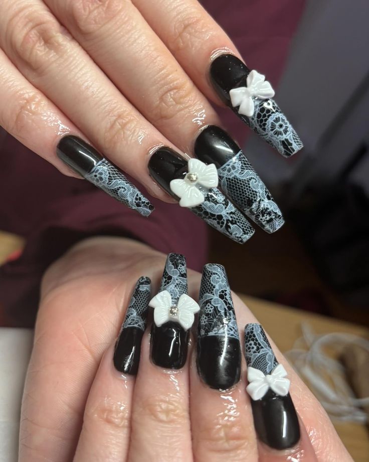 Sophisticated Long Tapered Nails with Black Base, White Lace Patterns, and Charming Bows.