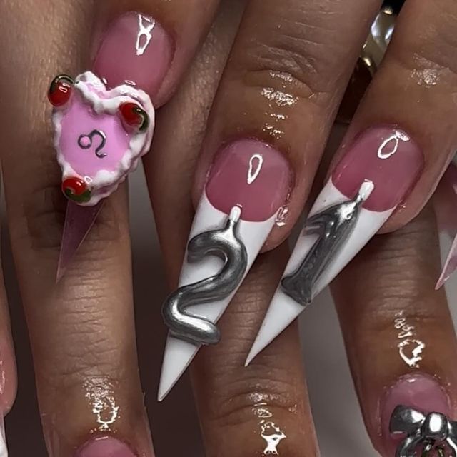 Creative Long Pointed Nail Design with Colorful Accents and Dramatic White Tips.