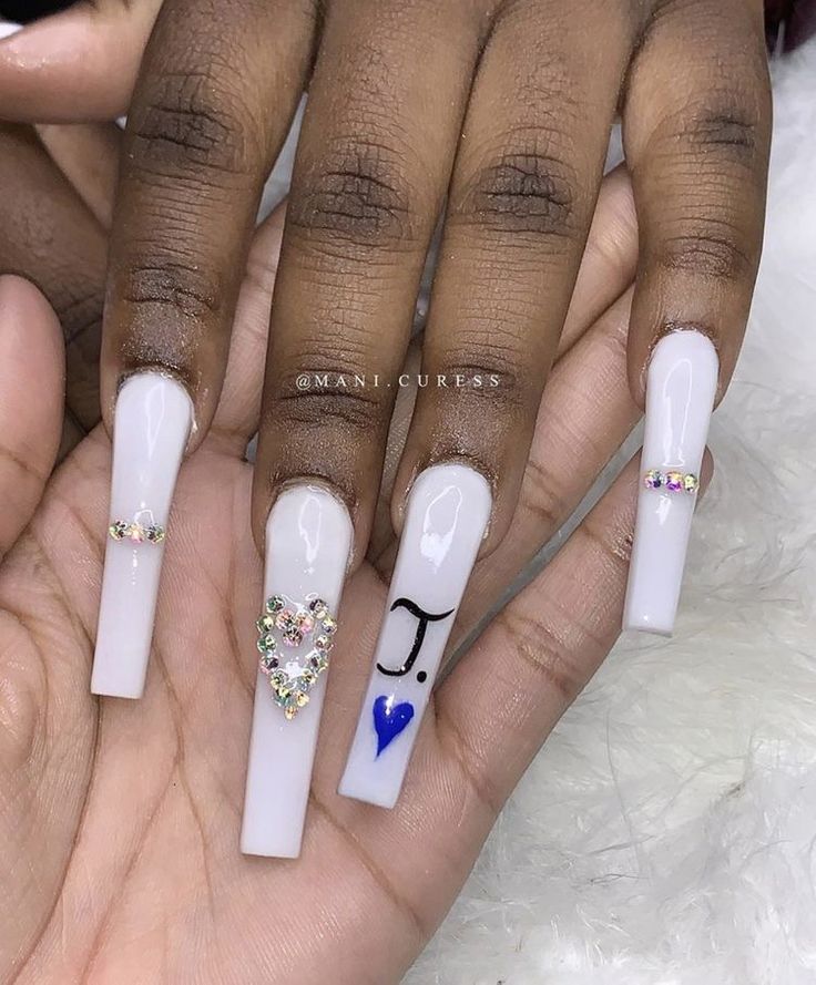 Sophisticated Elegant Long Nails with Artistic Designs and Colorful Gems.