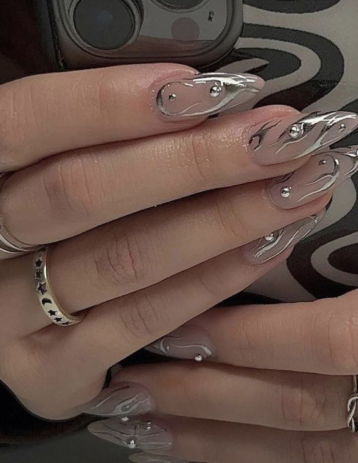 Sophisticated Nail Design: Nude Base with Swirling Silver Patterns and Decorative Beads