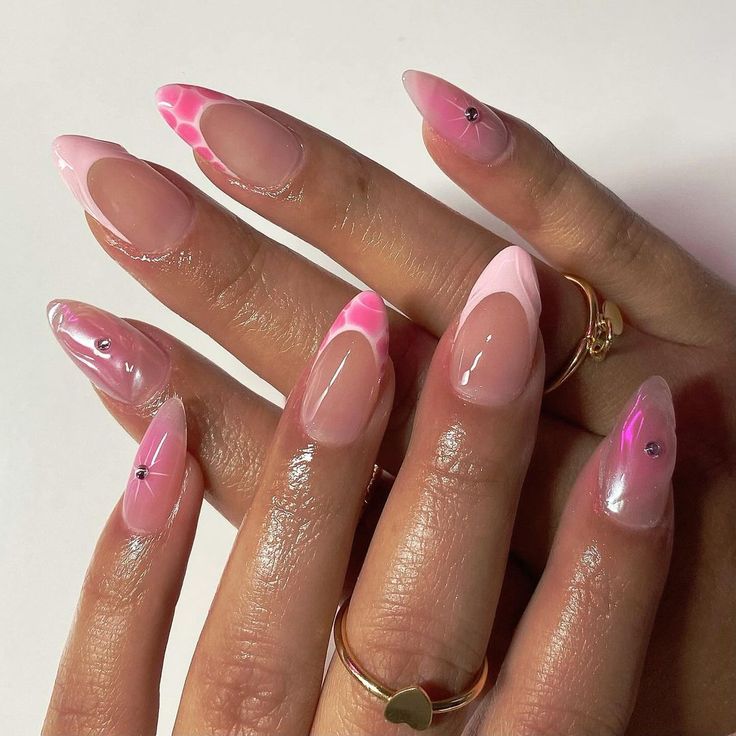 Chic Pink Ombre Nails with Stylish Patterns and Glamorous Rhinestones.