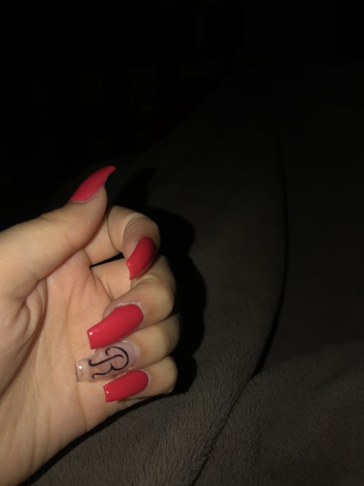 Bold Red Nails with Transparent Accent Create a Confident and Unique Look.