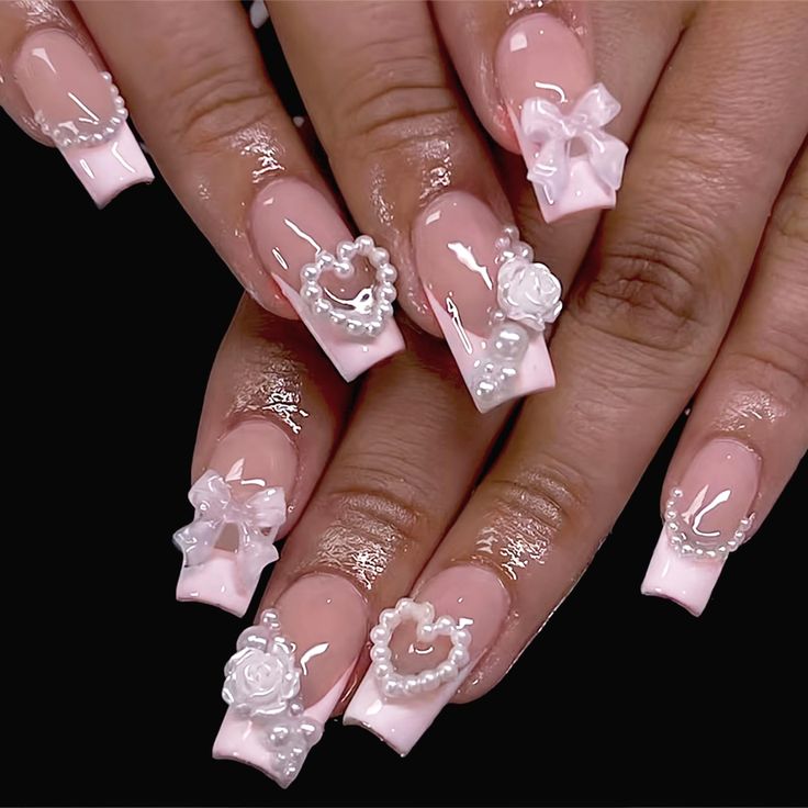 Romantic 3D Pink and White Nail Design with Floral Motifs and Glossy Finish.