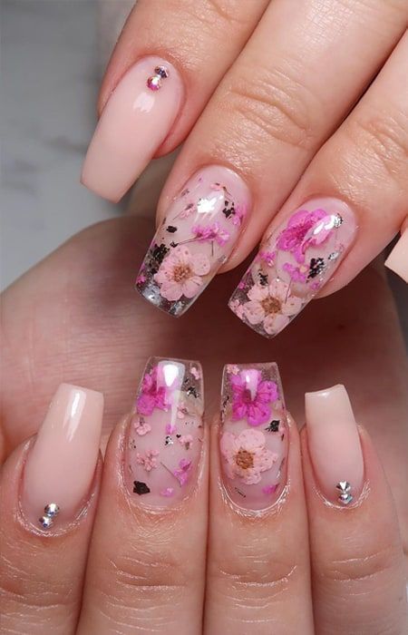 Elegant Floral Nail Design with Soft Nudes and Metallic Accents.