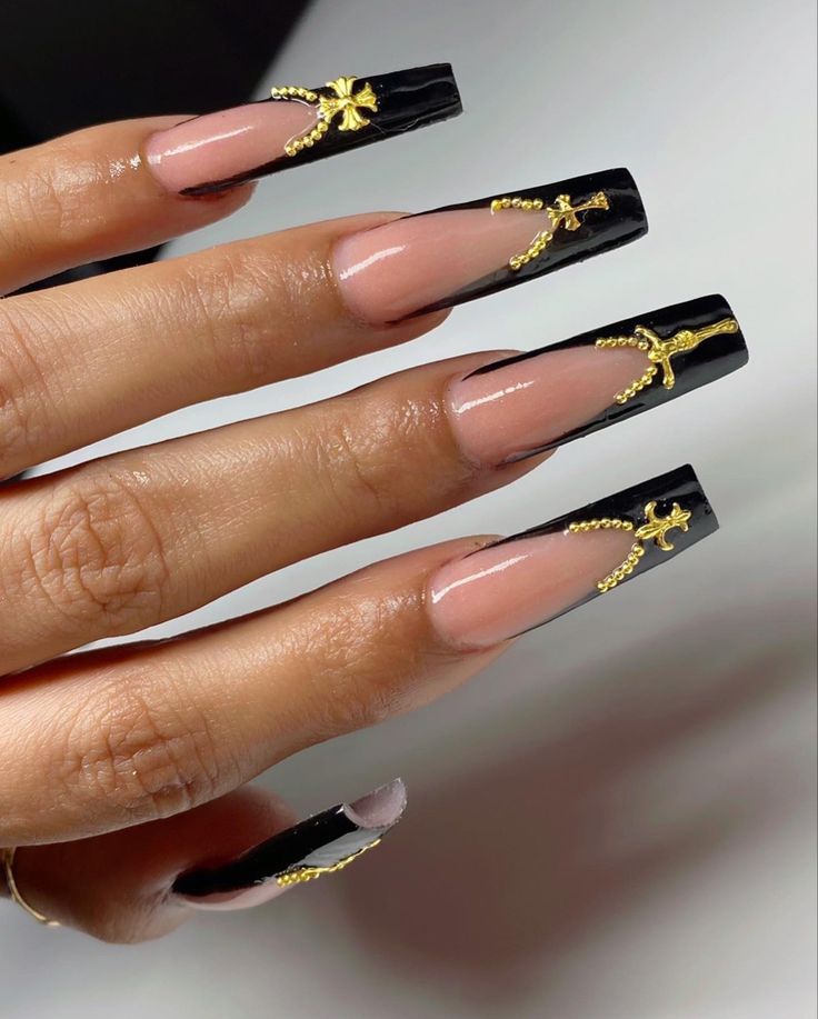 Glamorous Long Squared Nail Design with Glossy Black Finish and Gold Accents on Nude Base.