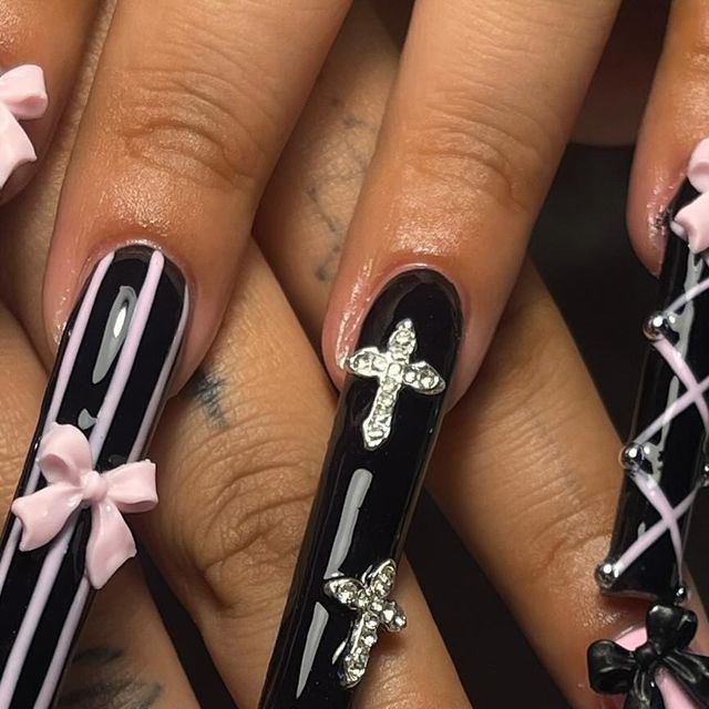 Chic Nail Design: Glossy Black with Playful Pink Accents and Elegant Embellishments