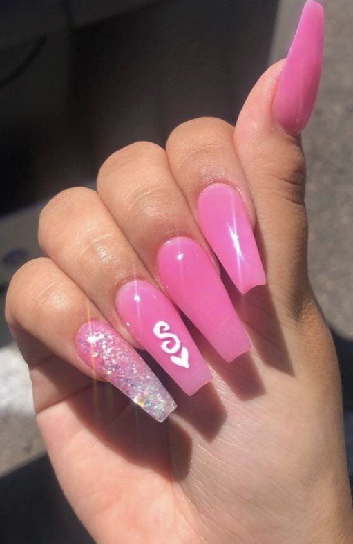 Chic Pink Stiletto Nail Design with Glitter Accent and Glossy Finish.