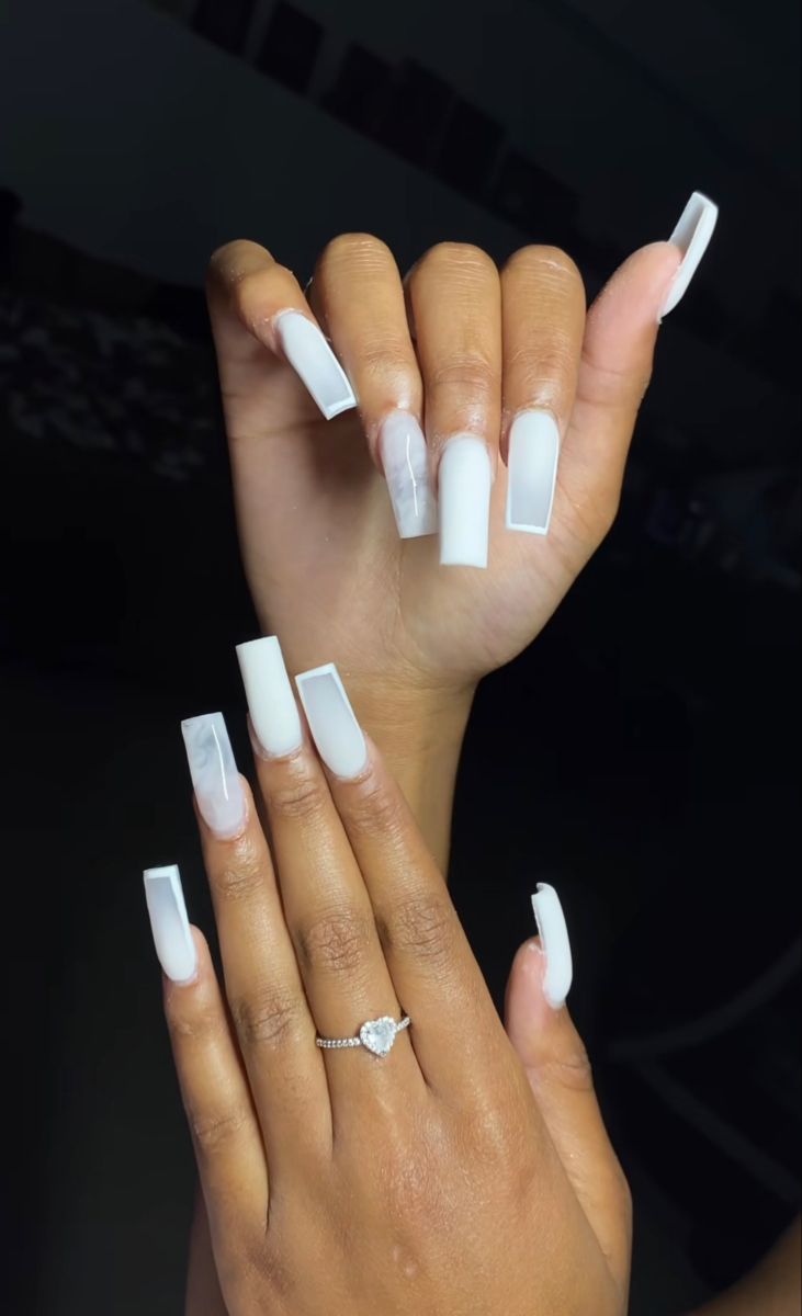 Chic and Sophisticated: Striking Long White Nails with Glossy Finish and Modern Shapes.