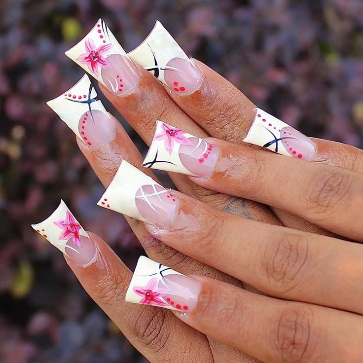 Sophisticated Pink and White Floral Nail Design with Striking Black Accents.