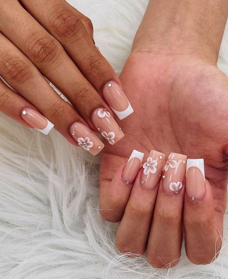 Elegant Nude Nail Design with White Tips and Floral Accents