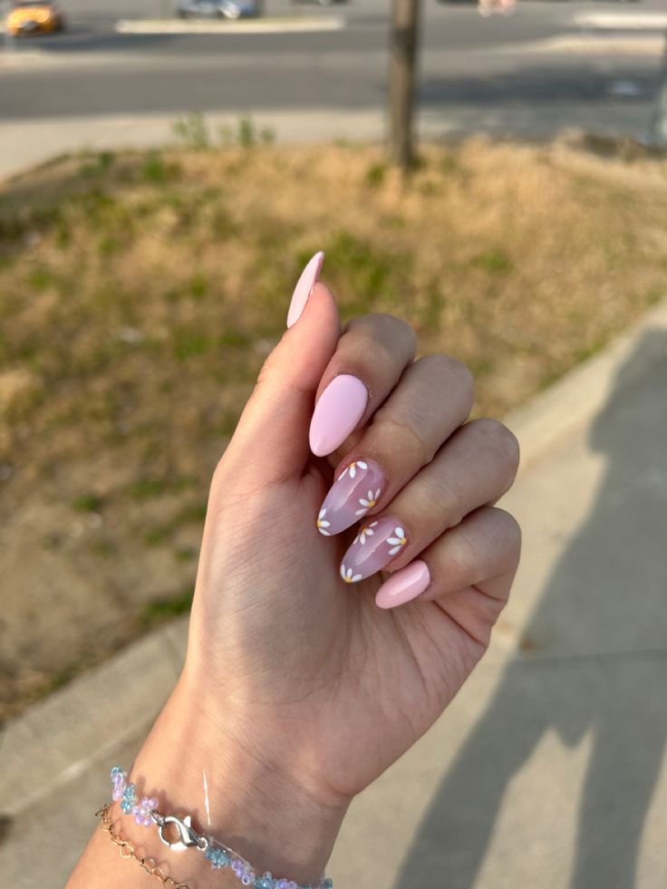 Sophisticated Soft Pink Nail Design with Glossy Finish and Delicate White Floral Accents.