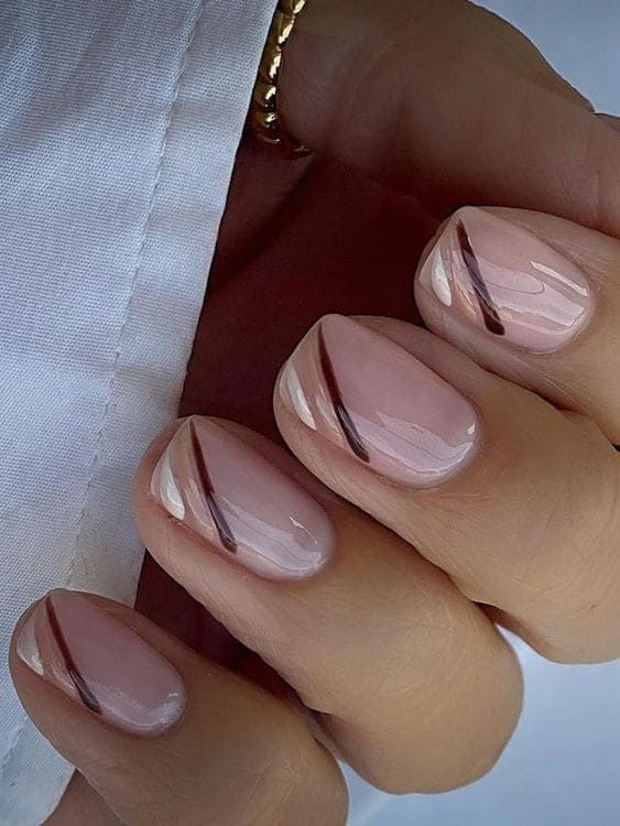 Chic Minimalist Nail Design: Soft Nude Base with Diagonal Lines and Glossy-Matte Finish.