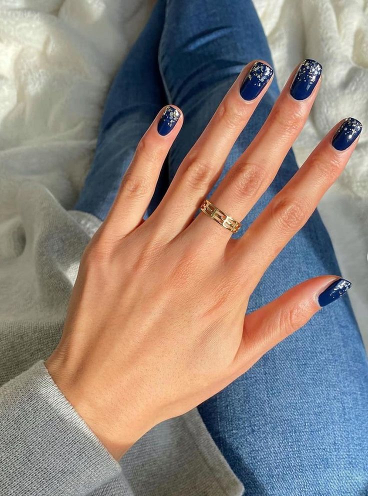 Elegant Navy Nail Design with Intricate Silver Floral Accents for a Glamorous Touch.