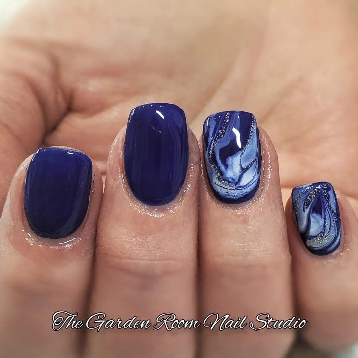 Elegant Vibrant Blue Nail Design with Glossy Finish and Artistic Marbling.