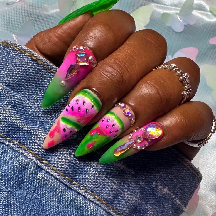 Playful Vibrant Watermelon Nail Design with Stiletto Shape and Gem Accents.