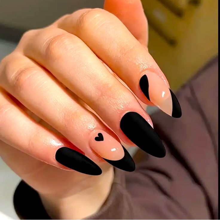 Chic Matte Black and Nude Nail Design with Creative Negative Space and Heart Accent