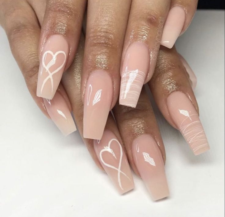 Elegant Nude Long Nails with Intricate White Designs and Romantic Gradient.