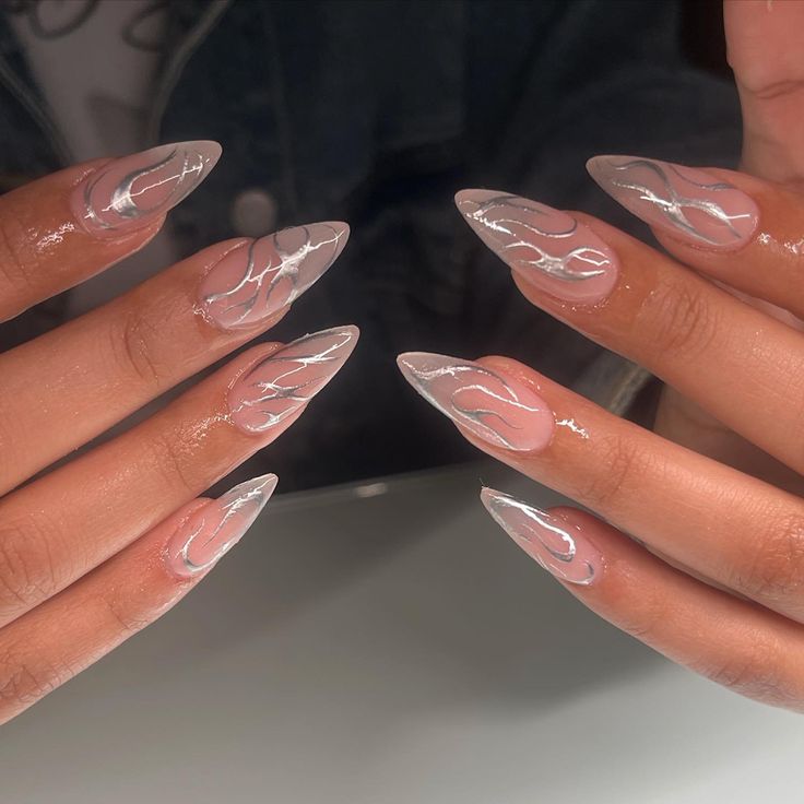 Elegant Stiletto Nails with Glossy Base and Subtle White Swirls for Modern Elegance.